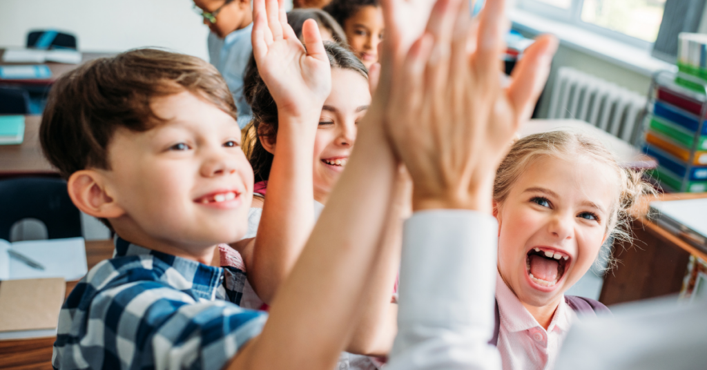 Multiple students excitedly giving high fives