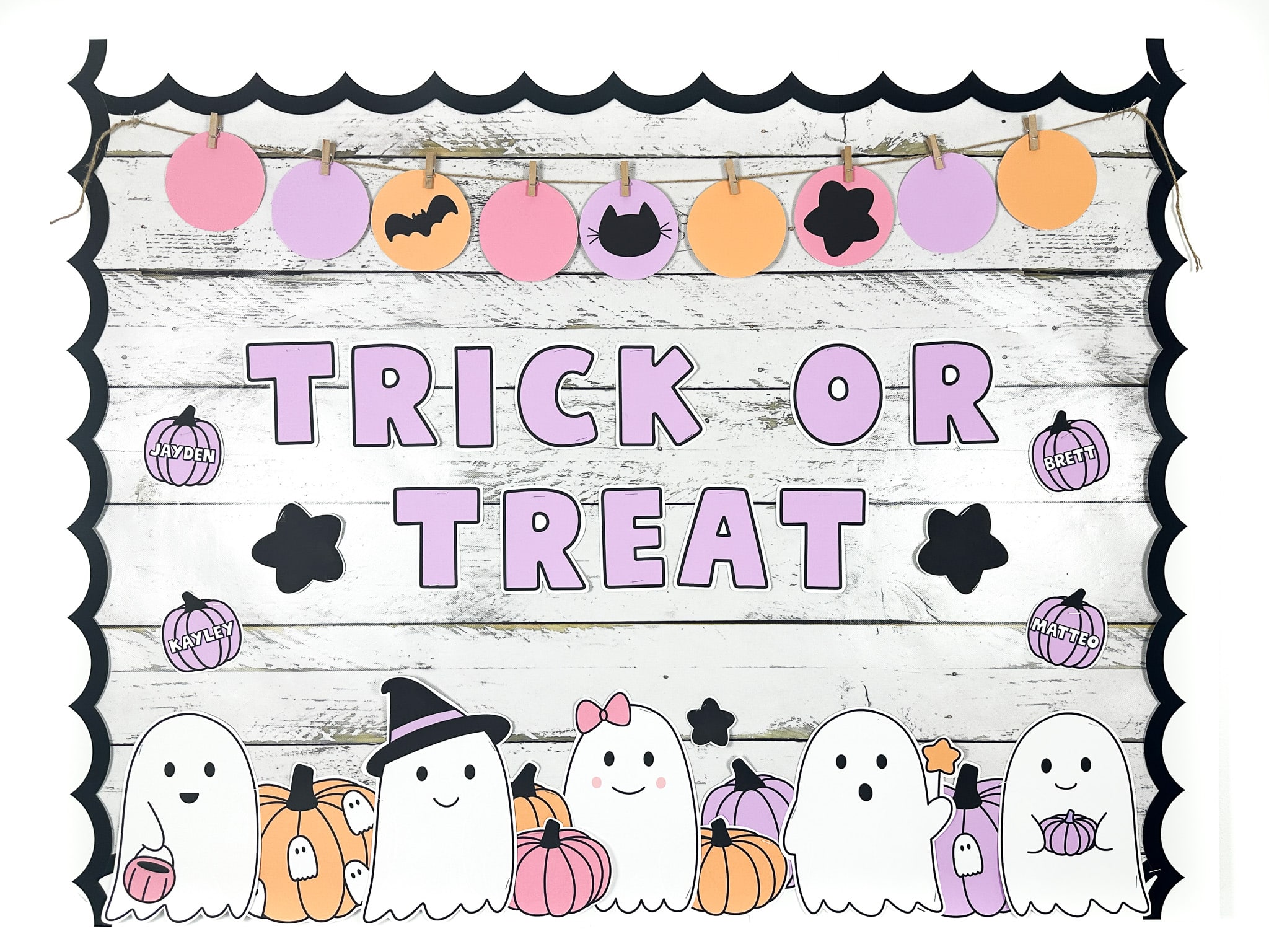 "Trick or treat" ghost halloween bulletin board with witch ghost, ghost with a wand, ghost holding a pumpkin, and a ghost with a bow