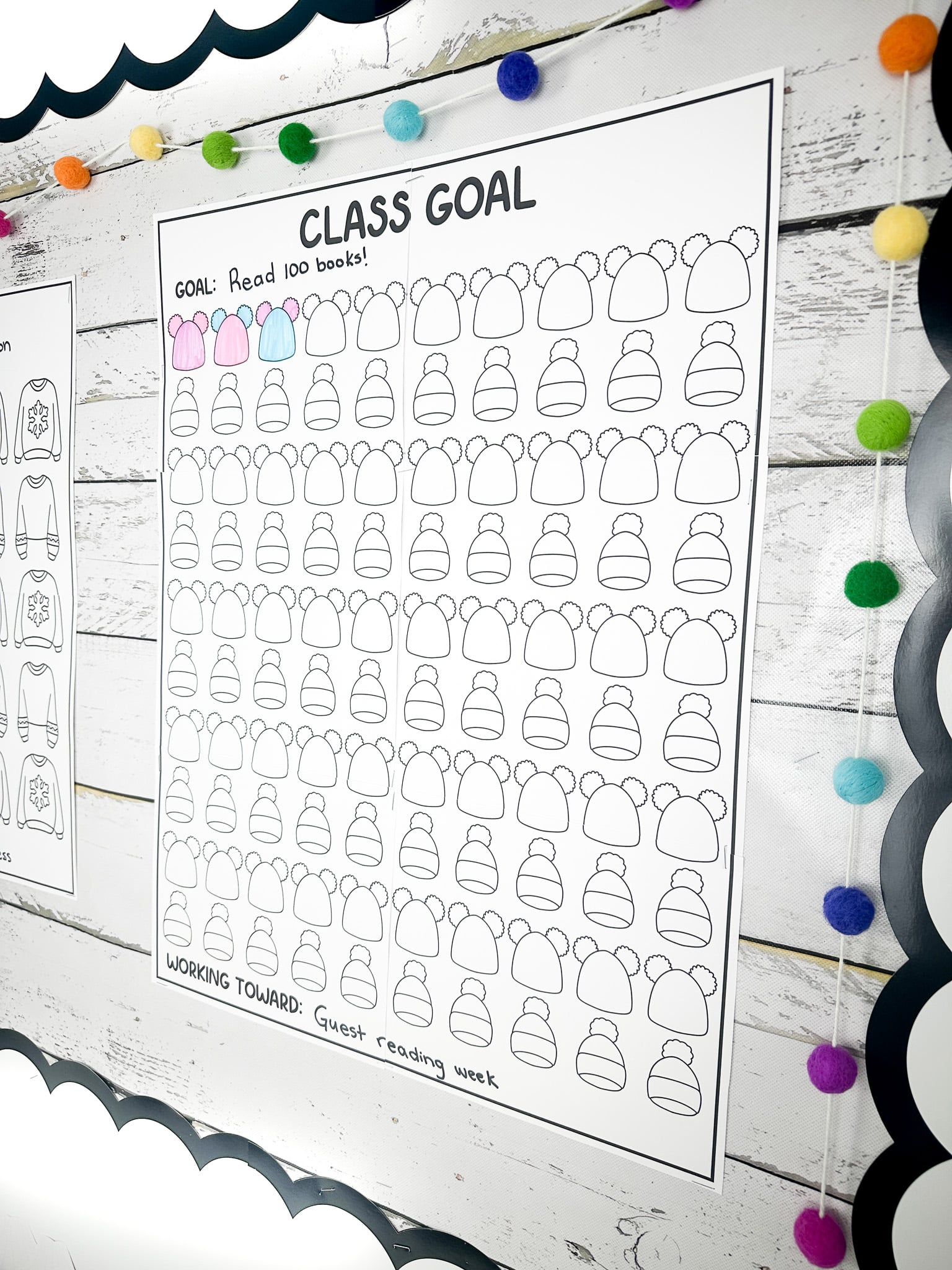 Class goals poster with the goal to read 100 books and three hats out of 100 are coloured in