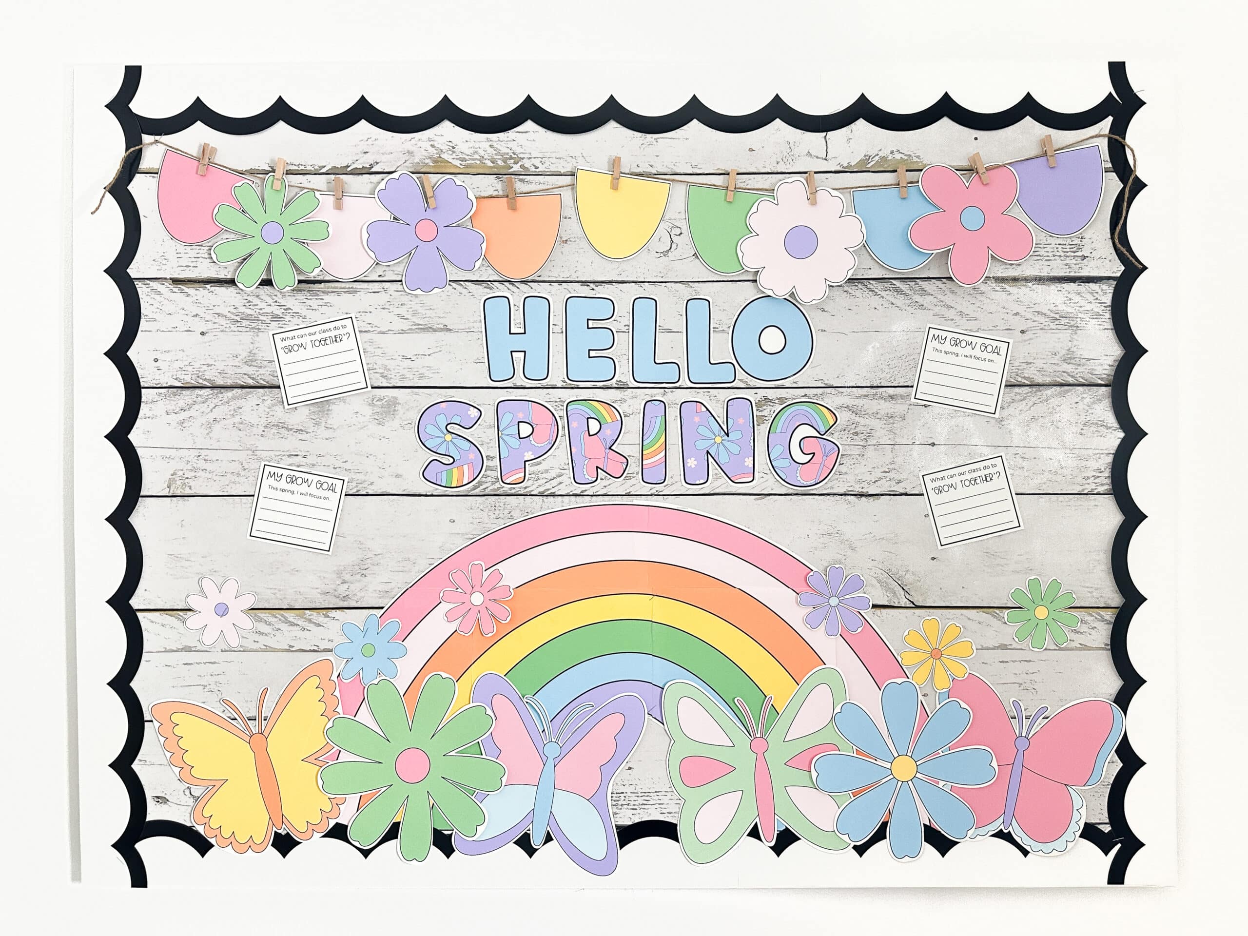 Spring bulletin board showing colourful rainbow, butterflies, daisies with the message "Hello Spring"