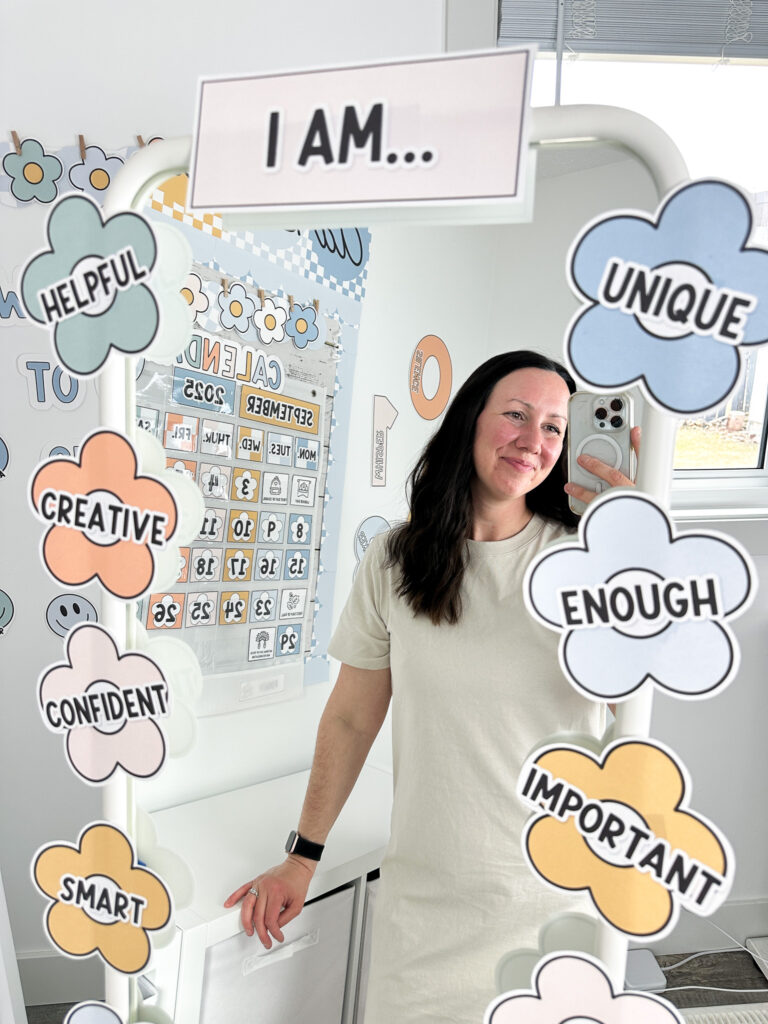 boho classroom decor affirmation station with a teacher taking a selfie in the mirror with the flower style affirmations around
